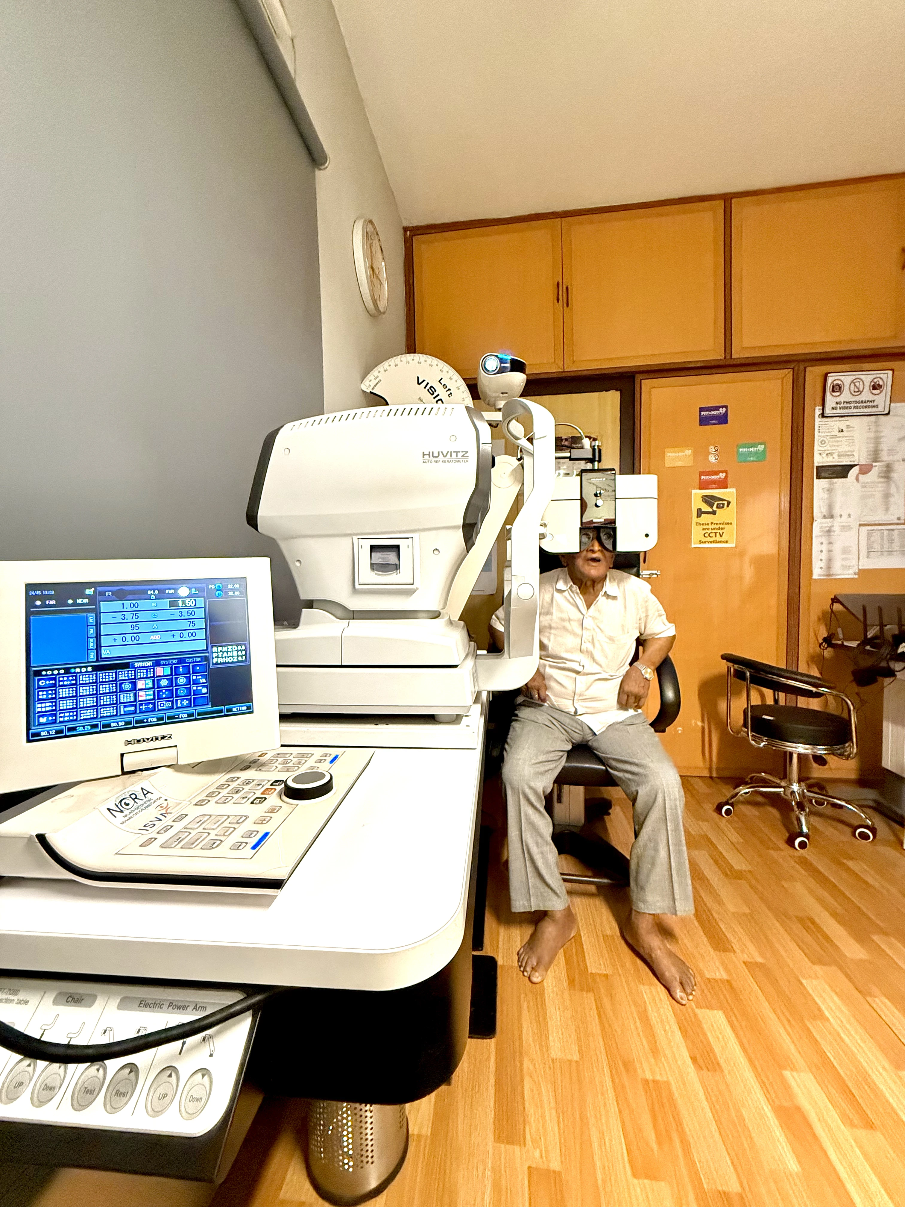 Auto-refractor examination in progress at Caring Vision Therapy clinic