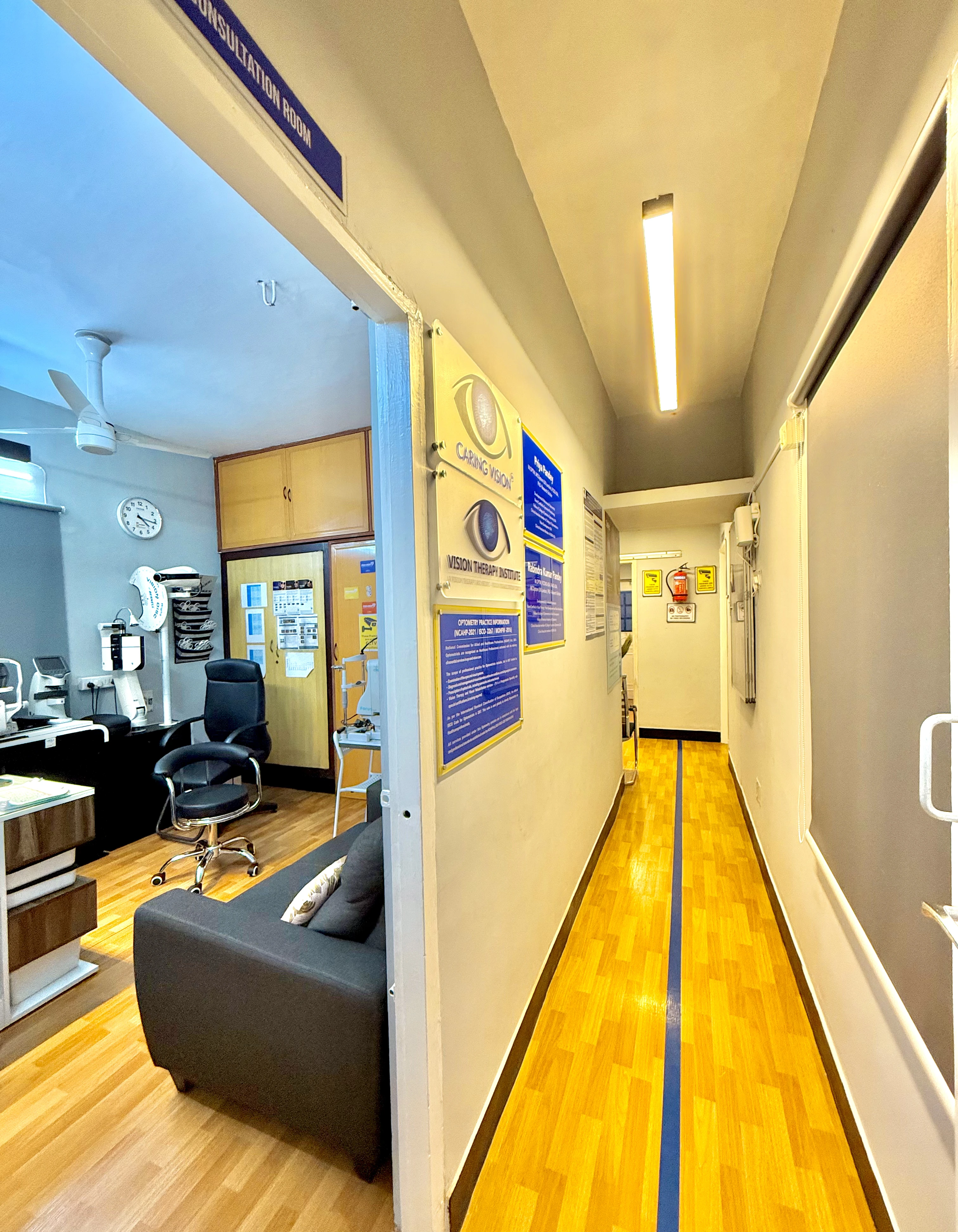 Corridor with consultation room signage at Caring Vision Therapy