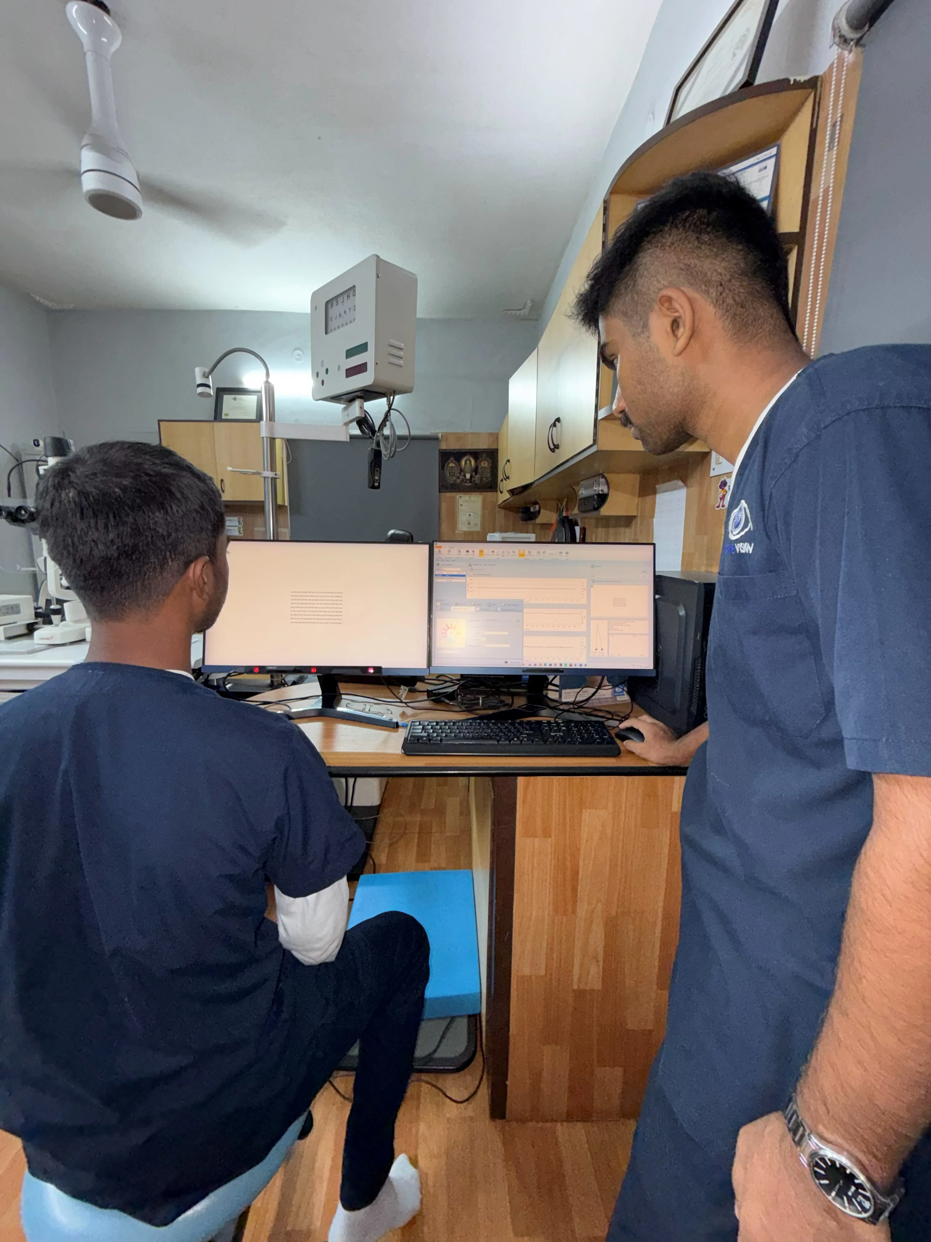 Multi-monitor vision assessment workstation at Caring Vision Therapy clinic