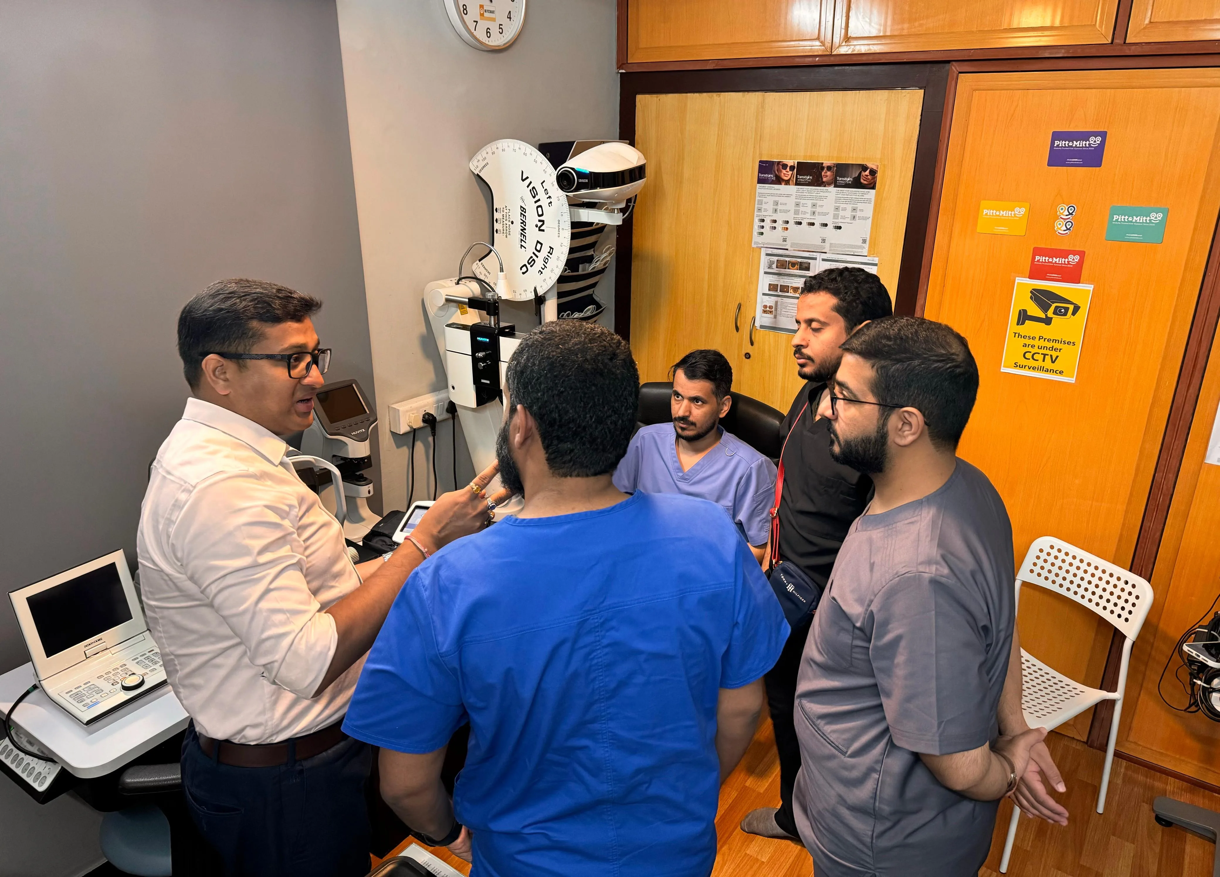 Trainees observing a live clinical demonstration during Optometry Training